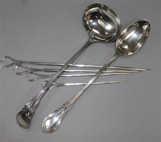 A silver plated ladle, serving spoon and four graduated skewers